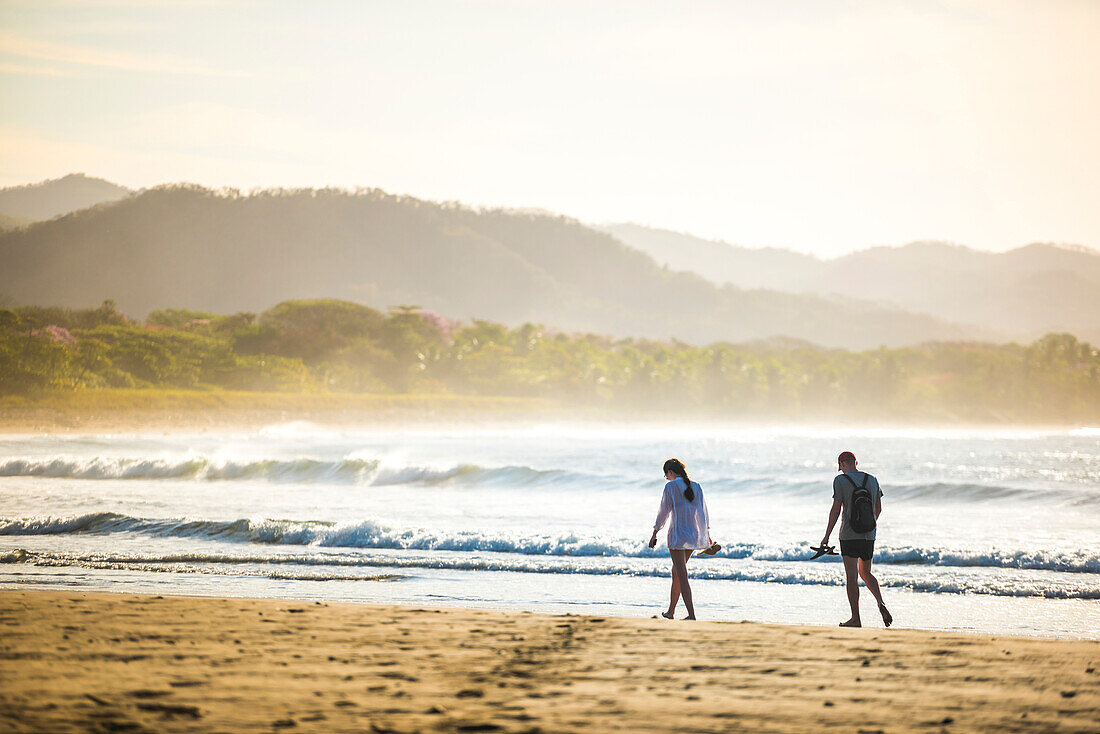 Couple on Playa Buena Vista Beach at sunrise, Guanacaste Province, Costa Rica, Central America