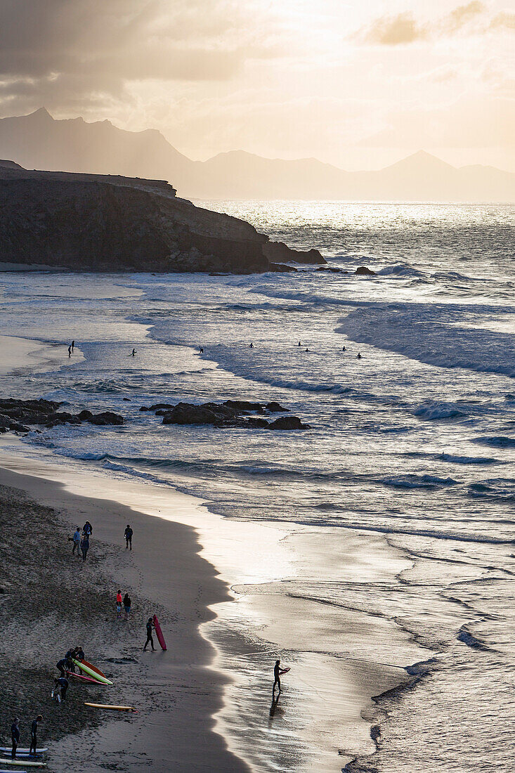 Surfers on Playa del Viejo Rey near La Pared on the volcanic island of Fuerteventura, Canary Islands, Spain, Atlantic, Europe