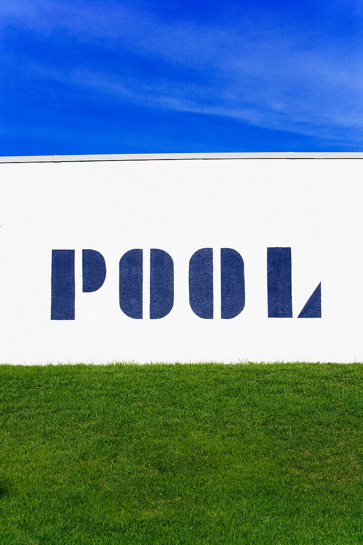 Pool sign, blue sky and grass at a public pool in Fargo, North Dakota.