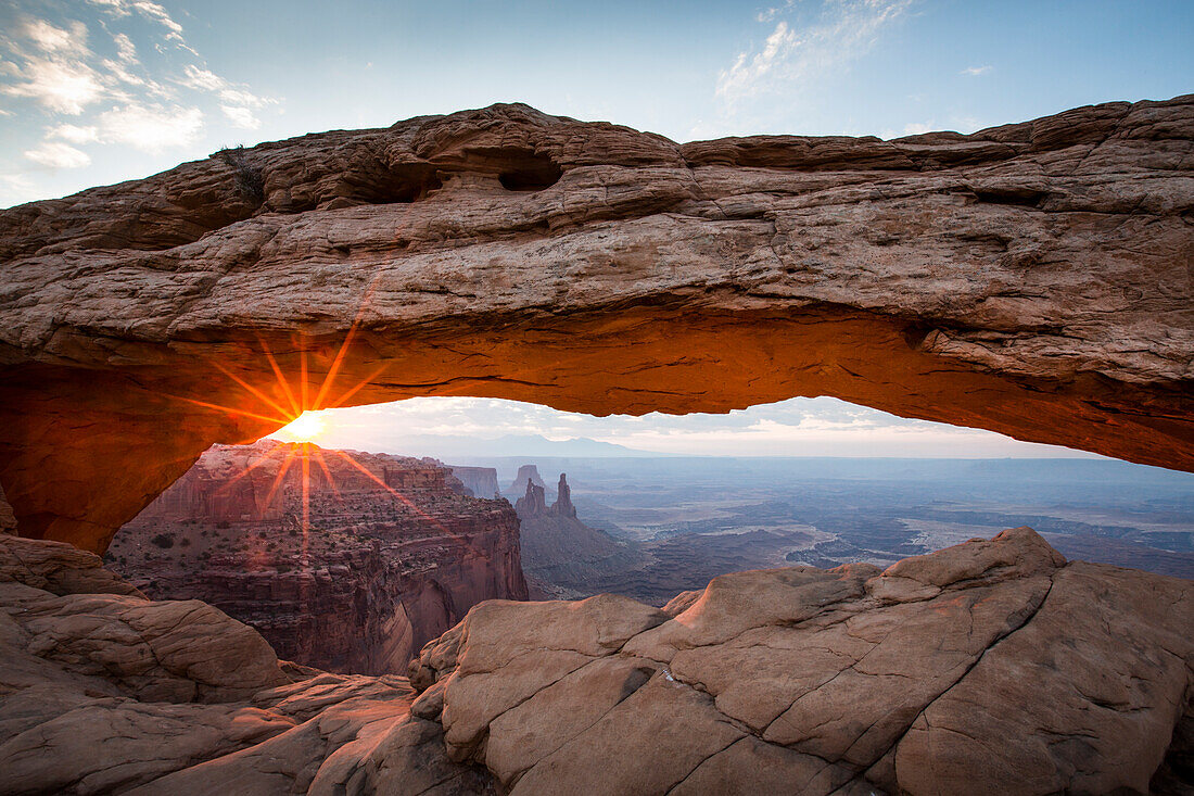 Sunrise at Mesa Arch in Canyonlands National Park, Utah. The site draws photographers from all over the world early each morning to capture the sunrise beneath the arch.