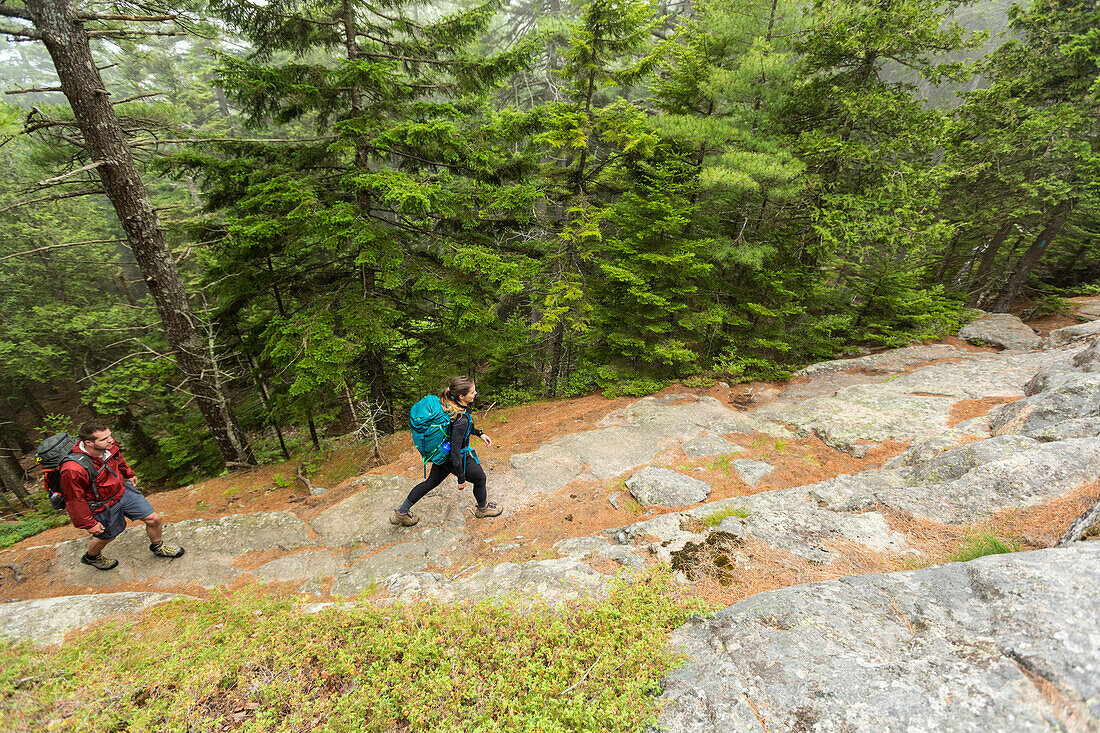 High angle view of couple walking on Beach Mountain in Acadia National Park, Maine, USA