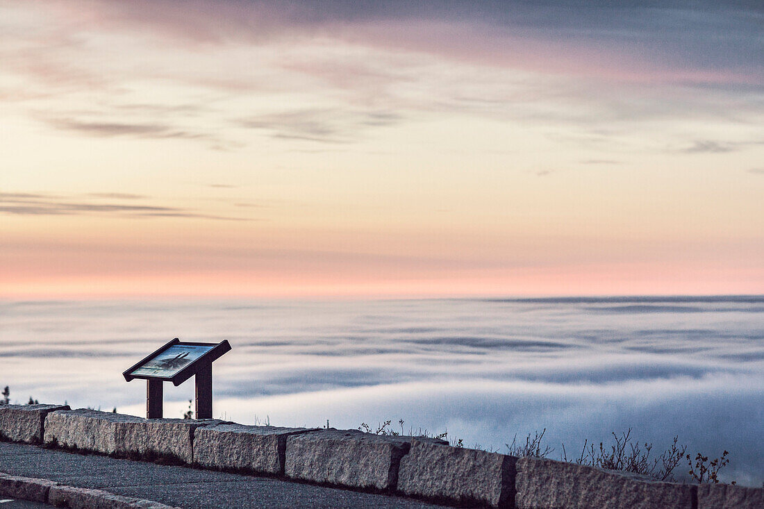 An information sign stands above the sounds on the top of Cadillac Mountain in Maine's Acadia National Park.