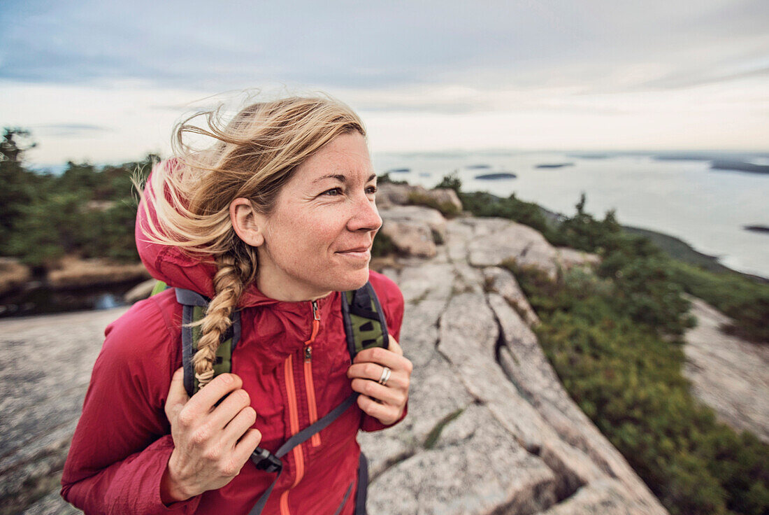 Woman hiking at summit of Pemetic Mountain, Acadia National Park, Maine, USA