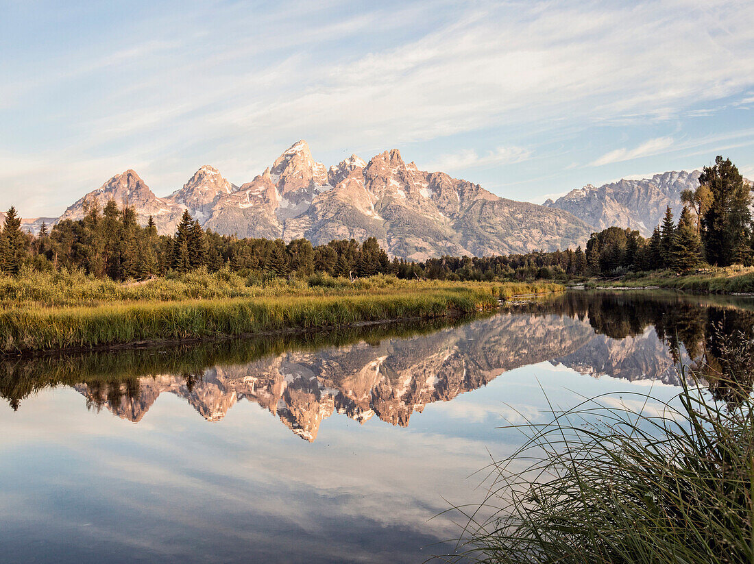 The Tetons are reflected in the Snake River near Jackson Hole, Wyoming.