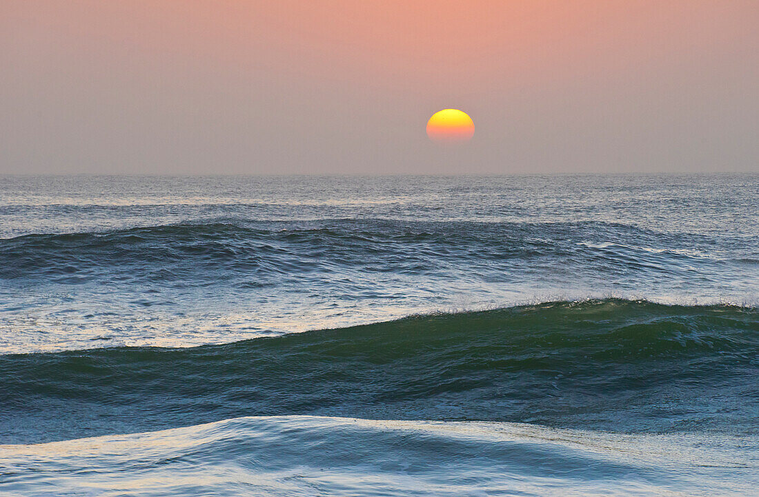 Sun setting over ocean, Cape Cross, Namibia