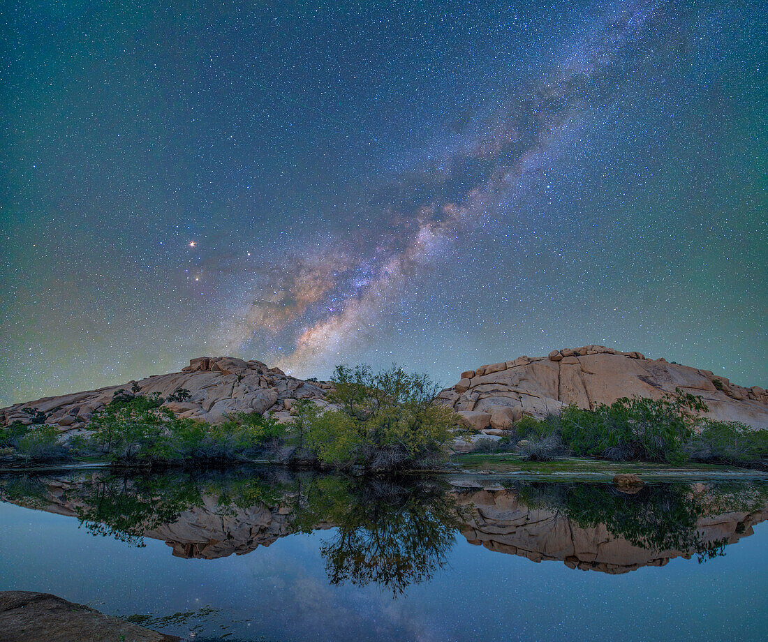 Milky way over pond at night, Barker Pond Trail, Joshua Tree National Park, California