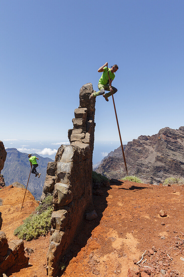 men jumping with the canarian crook, Salto del Pastor Canario, crater rim, Caldera de Taburiente, UNESCO Biosphere Reserve, La Palma, Canary Islands, Spain, Europe