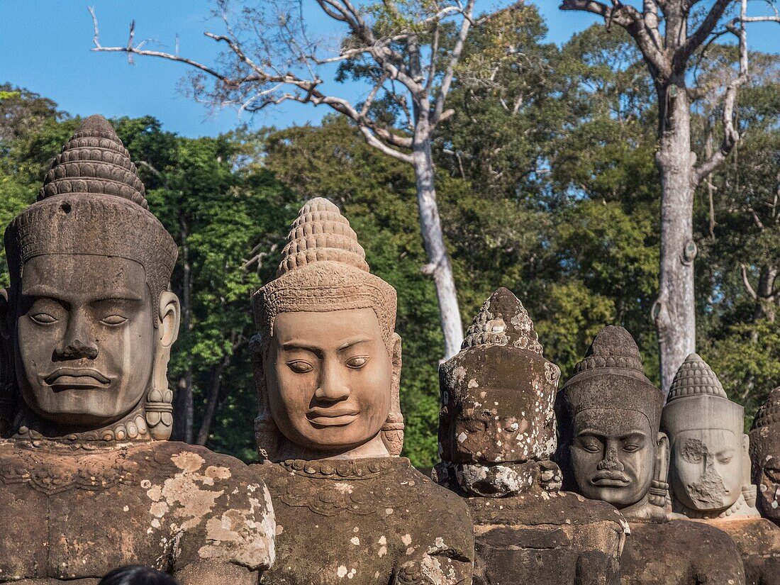 Detail of the stone faces on the bridge at the south gate of Angkor Thom, Angkor Temples complex, Cambodia, Asia