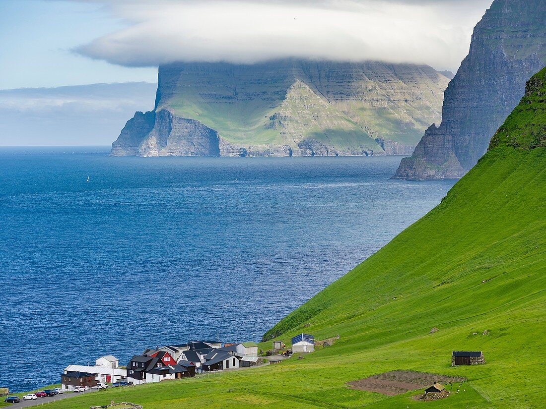 Island Kalsoy, village Trollanes, in background the island Kunoy and Vidoy. Nordoyggjar (Northern Isles) in the Faroe Islands, an archipelago in the north atlantic. Europe, Northern Europe, Scandinavia, Denmark, Faroe Islands.