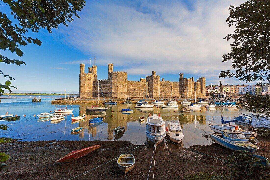 Caernarfon or Carnarvon or Caernarvon, Gwynedd, Wales, United Kingdom. Caernarfon Castle seen across the River Seiont. It is part of the UNESCO World Heritage Site which includes a group of Castles and Town Walls of King Edward in Gwynedd. Harlech and Bea