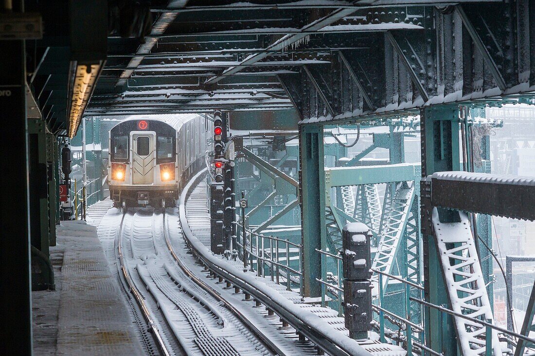 A Flushing Line train arrives at the Queensboro Plaza station in New York during the city's first major winter storm of the season. Meteorologists are forecasting between 8 and 14 inches of snow in the New York City region. The Metropolitan Transportation