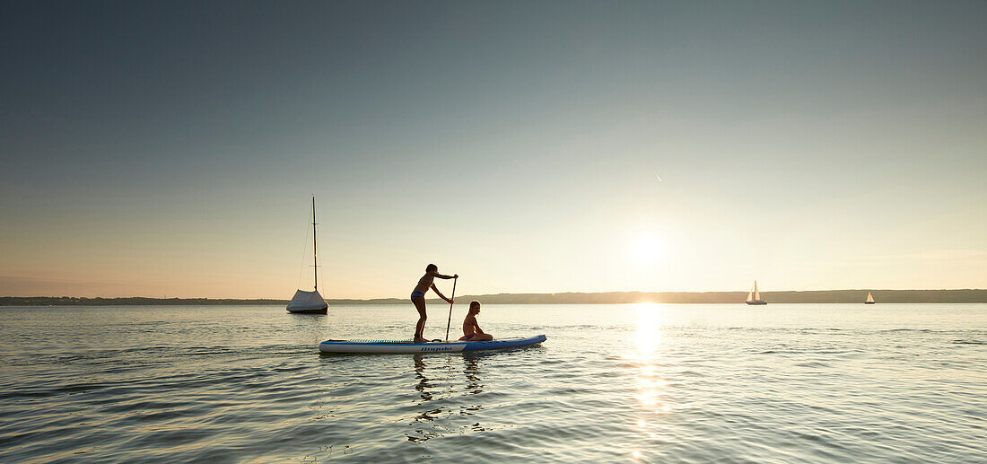 SYoung tand Up Paddler on Lake Starnberg,  Lake Starnberg, Bavaria, Germany