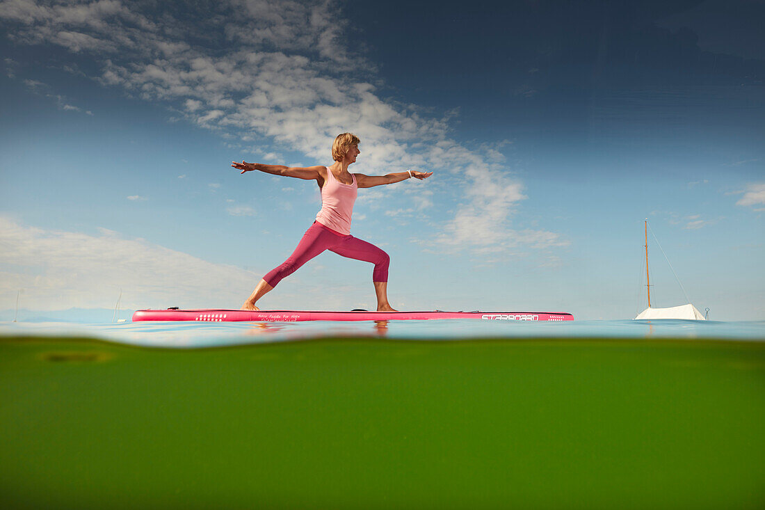 Yoga Teacher on SUP Board,  Lake Starnberg, Bavaria, Germany