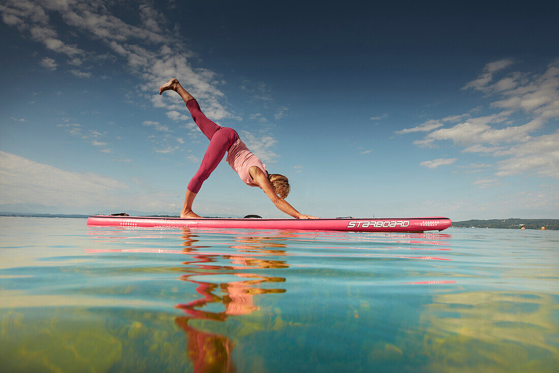 Yoga Teacher on SUP Board,  Lake Starnberg, Bavaria, Germany