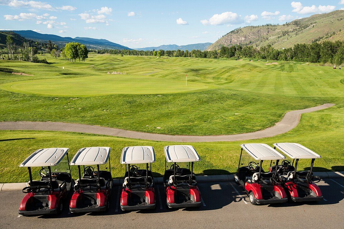 A row of golf carts at the Dunes golf course in Kamloops, BC, Canada.