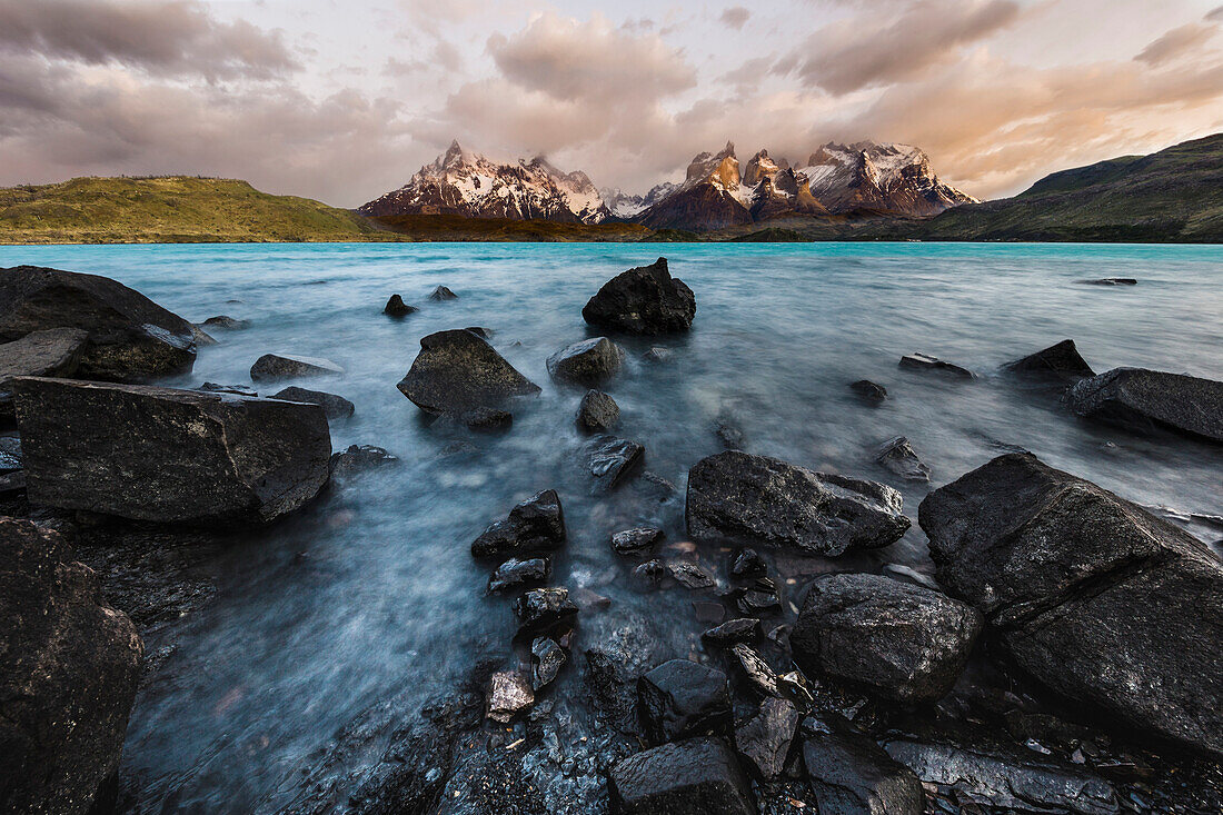 Rocks along lakeshore and granite peaks in spring, Lake Pehoe, Torres del Paine, Torres del Paine National Park, Patagonia, Chile