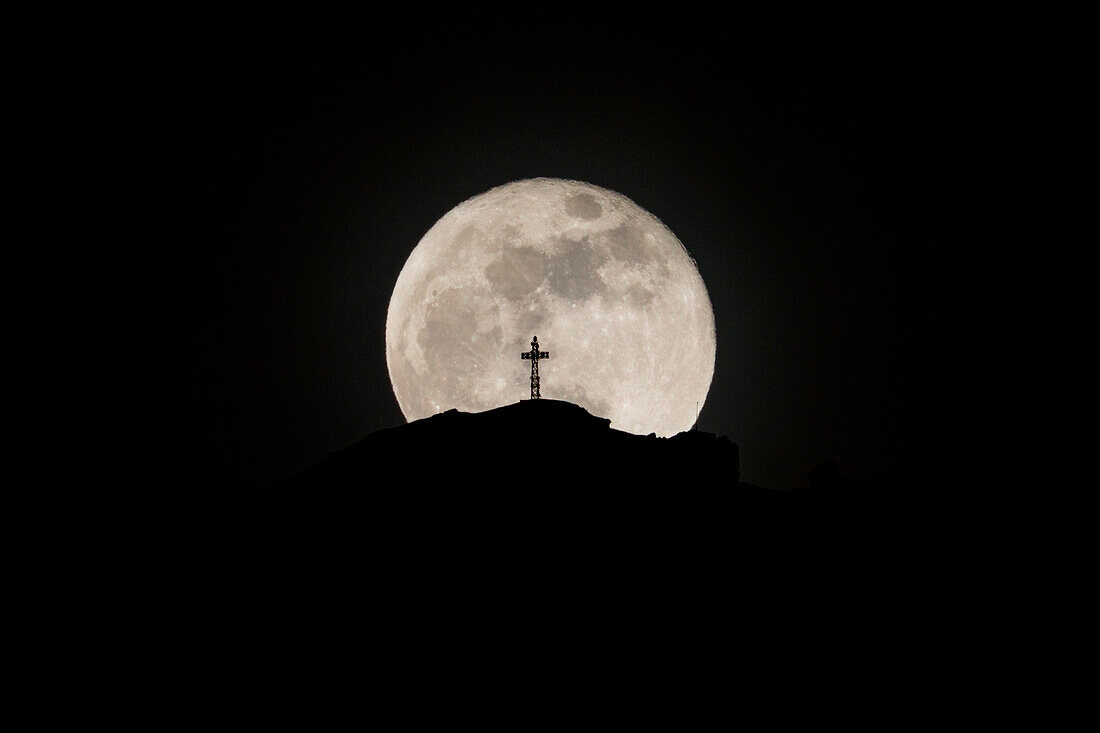 Silhouette of Resegone mountain summit highlighted by the moon, Lecco, province of Lecco, Lombardy, Italy