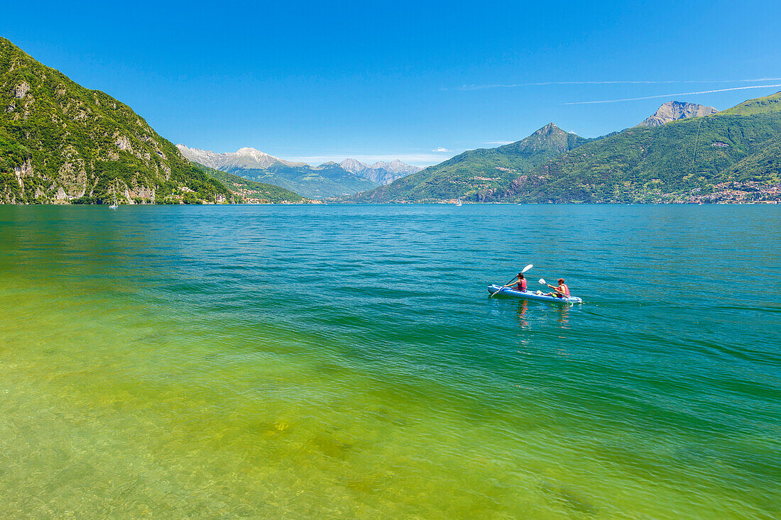 Two guys go canoeing on lake Como, Menaggio, Como province, Lombardy, Italy, Europe