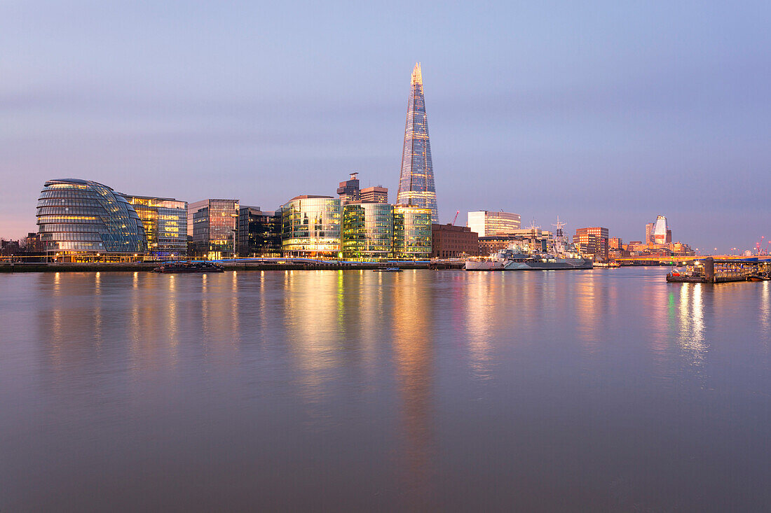 Southwark area with City Hall and Shard reflected in river Thames at dawn, London, Great Britain, UK