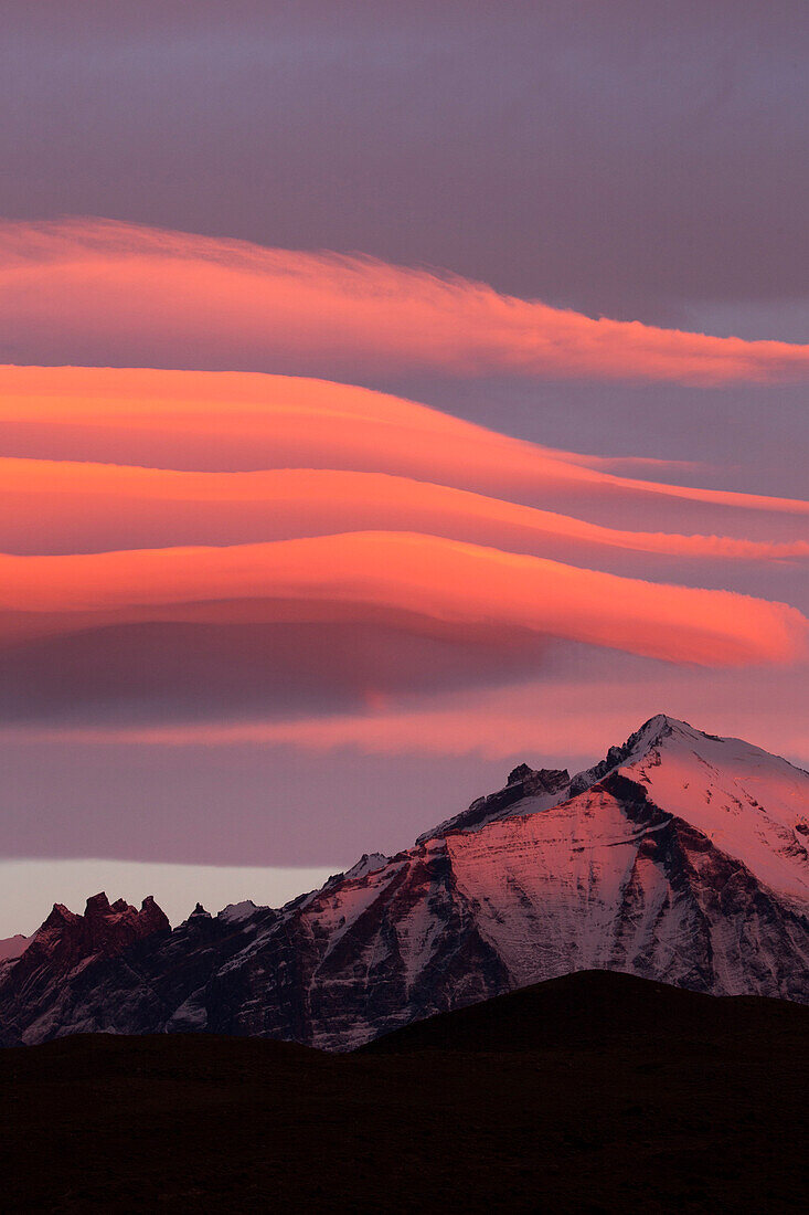 Clouds at sunrise over mountain range, Torres del Paine National Park, Patagonia, Chile