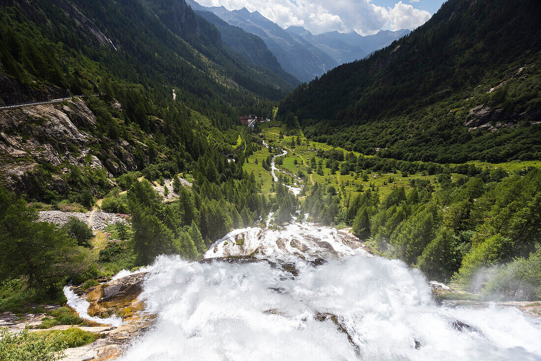 View of the jump of Cascata del Toce waterfall and Formazza Valley in summer. Frua hamlet, Formazza, Valle Formazza, Verbano Cusio Ossola, Piedmont, Italy.