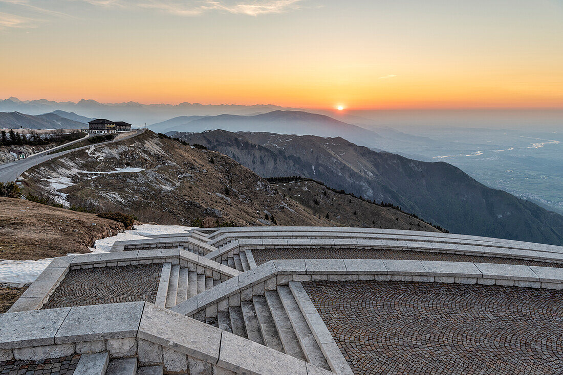 Monte Grappa, province of Treviso, Veneto, Italy, Europe. Sunrise over the Venetian plain, seen from the stairs at the military memorial monument