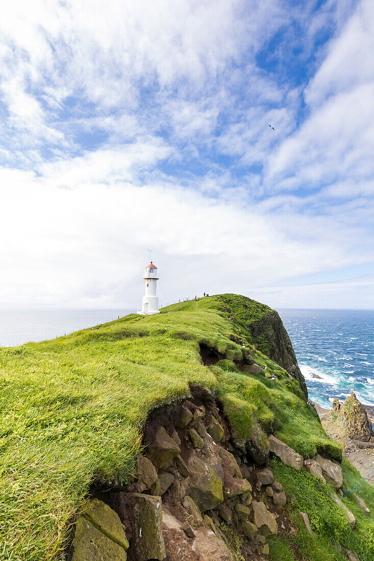 Lighthouse on islet known as Mykines Holmur, Mykines island, Faroe Islands, Denmark