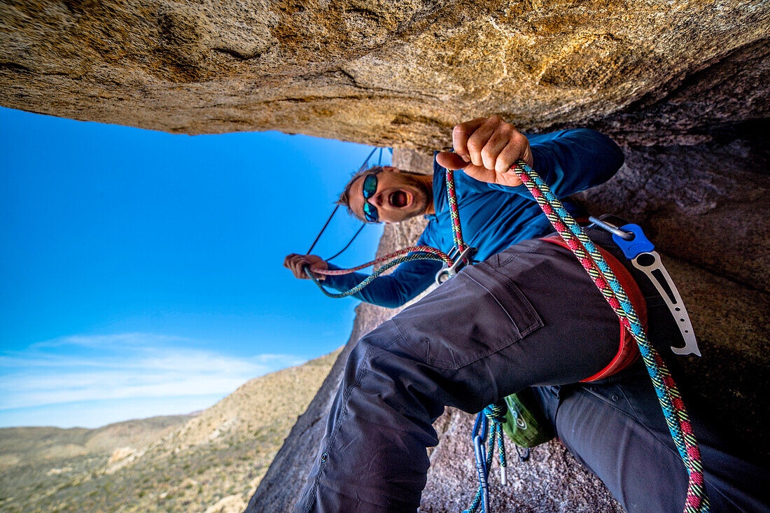 A man belays a technical rock climb in Joshua Tree National Park, California.