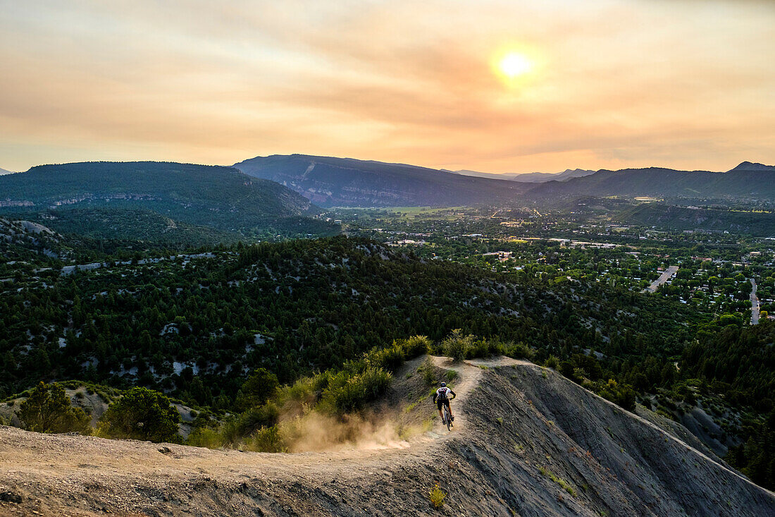 Male Mountain Biker in scenic landscape rides down Hogs back near Durango, Colorado, USA