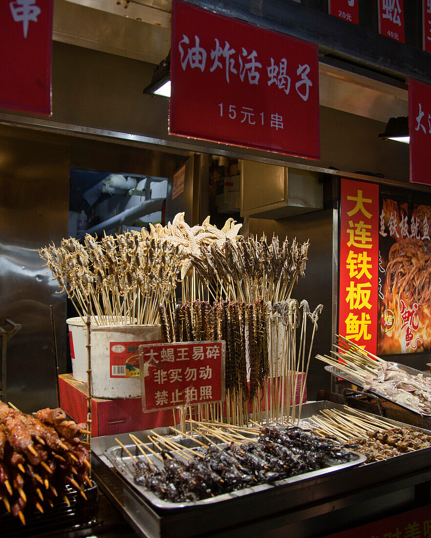 Food on skewers at night market, Beijing, China