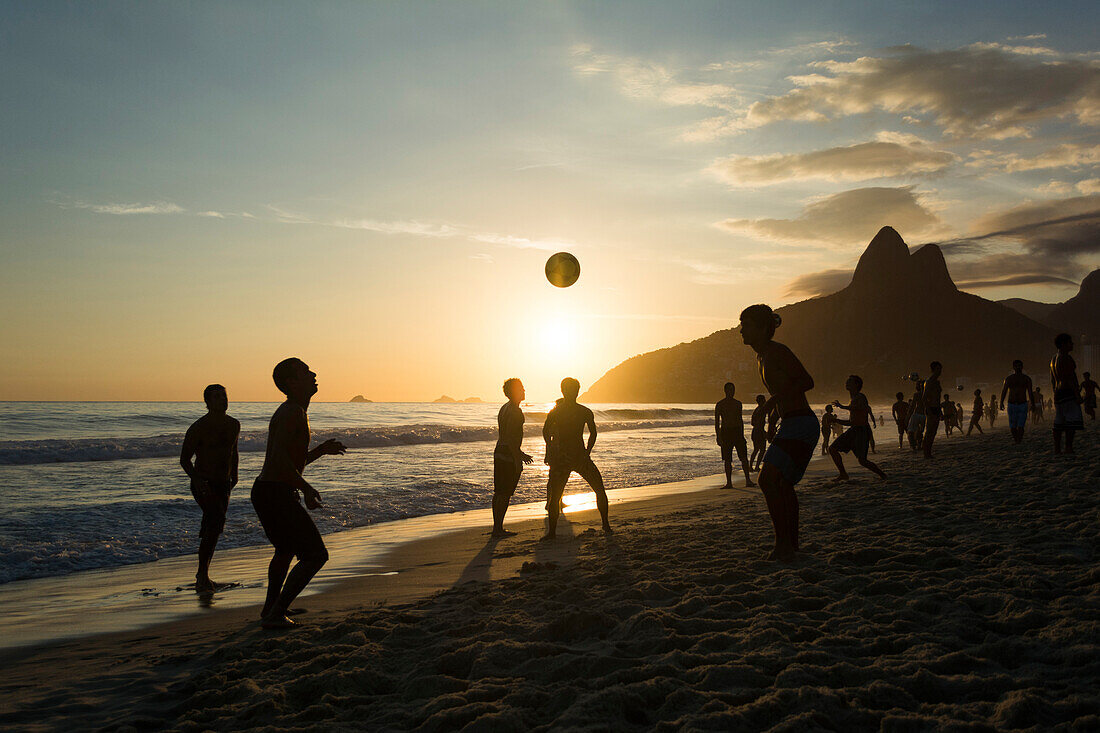 Locals playing soccer in Ipanema Beach by the sunset, Rio de Janeiro, Brazil