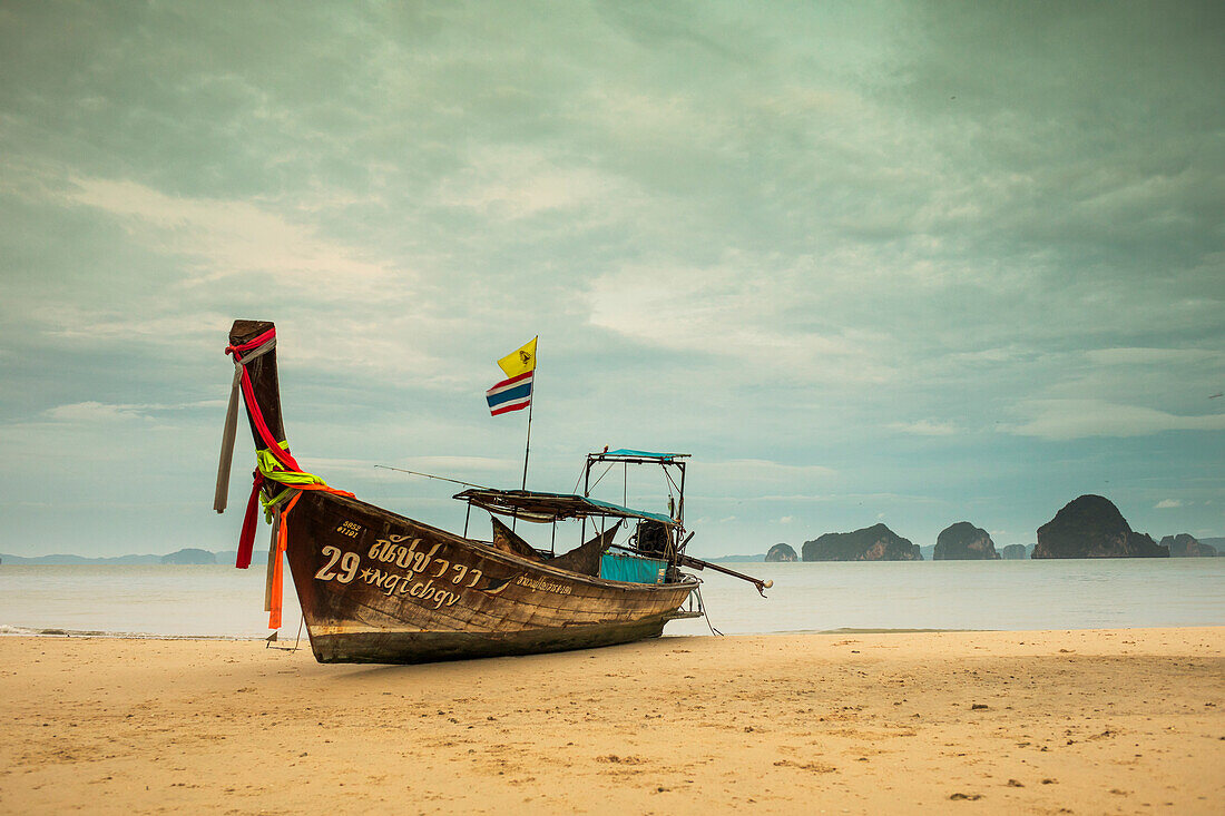 Long-tail boat moored on beach during daytime, Krabi, Krabi Province, Thailand
