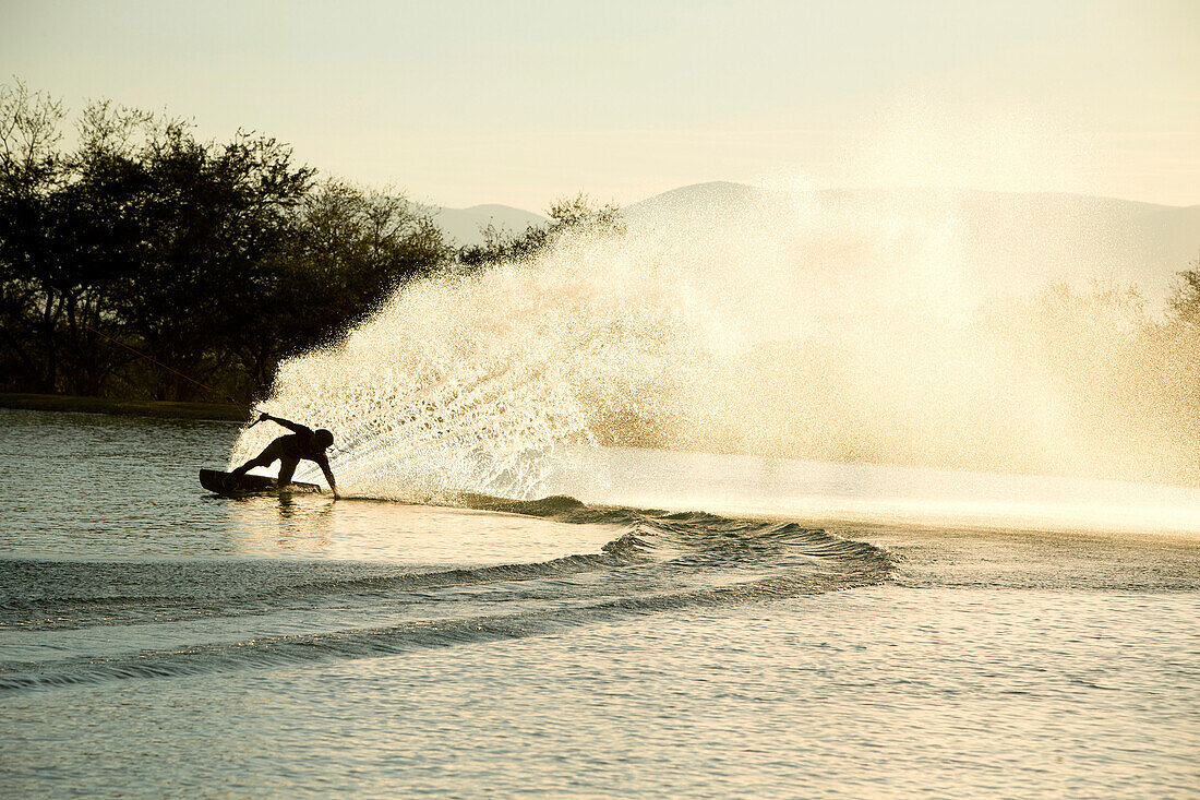 Wakeboarder spraying water during tight turn, Tequesquitengo, Morelos, Mexico