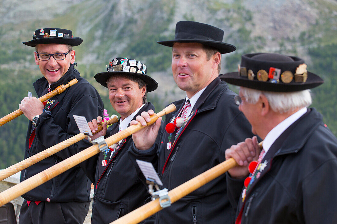 Four traditionally dressed locals of Zermatt play the Alphorn in front of the Matterhorn mountain.     With the passing of time, the alphorn almost totally disappeared as an instrument used by Swiss shepherds. It was only with the romanticism of the 19th 