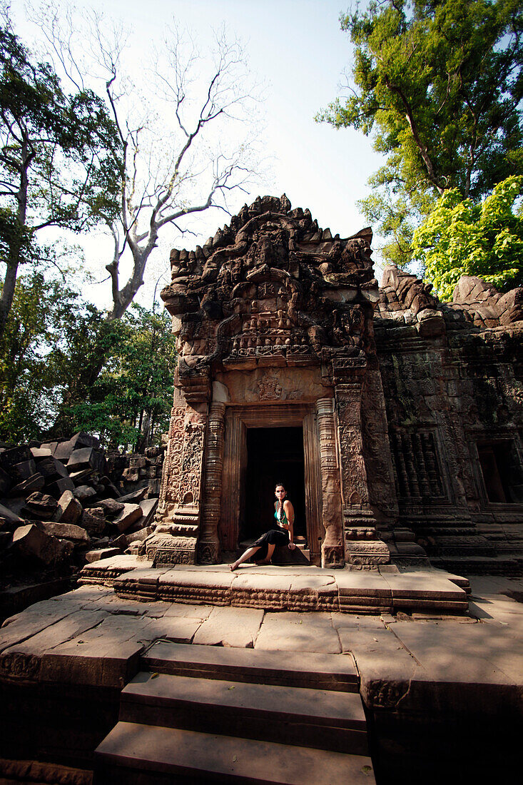 Photograph of beautiful woman posing in temple of Angkor Wat, Siem Reap Province, Cambodia