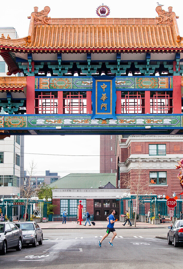 Side view of runner jogging through Chinatown, Seattle, Washington State, USA