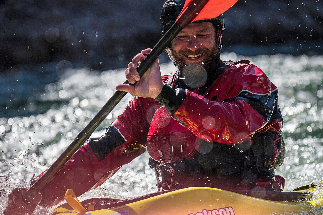 Close up of male kayaker smiling while kayaking on Snake River, Jackson Hole, Wyoming, USA