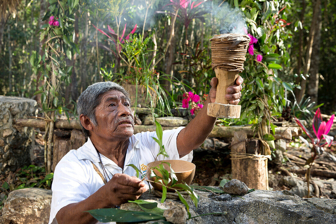 Local Shaman praying before his welcome ceremony at village near Cob, in Quintana Roo, Mexico