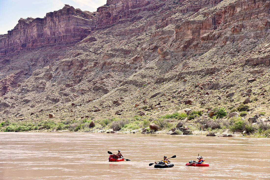 Three adventurous women rafting in river in Canyonlands National Park, Moab, Utah, USA