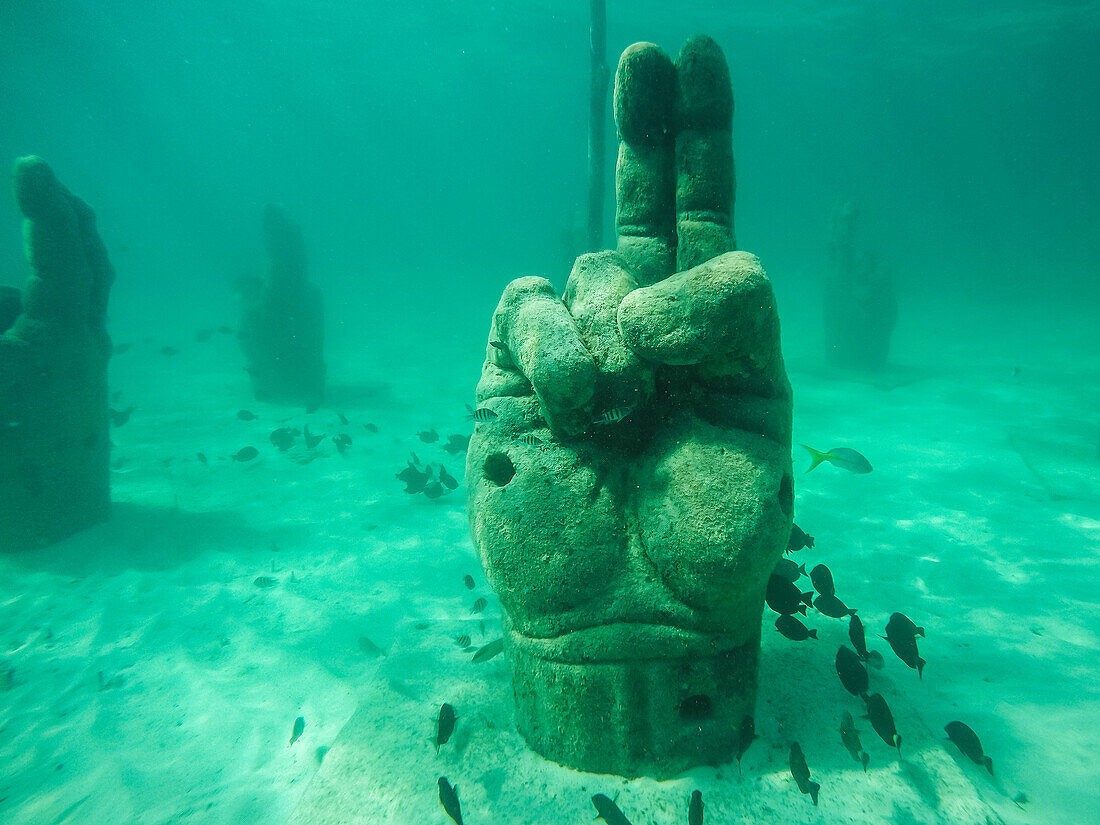 Stone hand is set underwater to attract fish while snorkeling off coast, Cancun, Yucatan Peninsula, Mexico