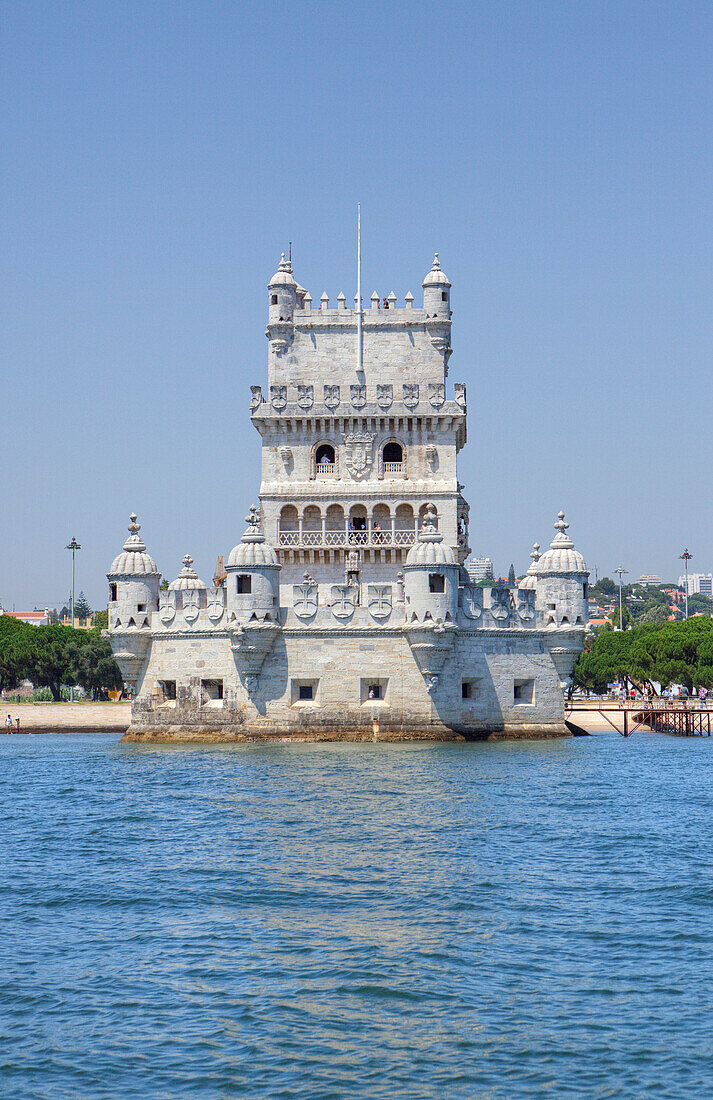 Fortified Belem Tower standing against clear sky on shore of Tagus river, Lisbon, Portugal
