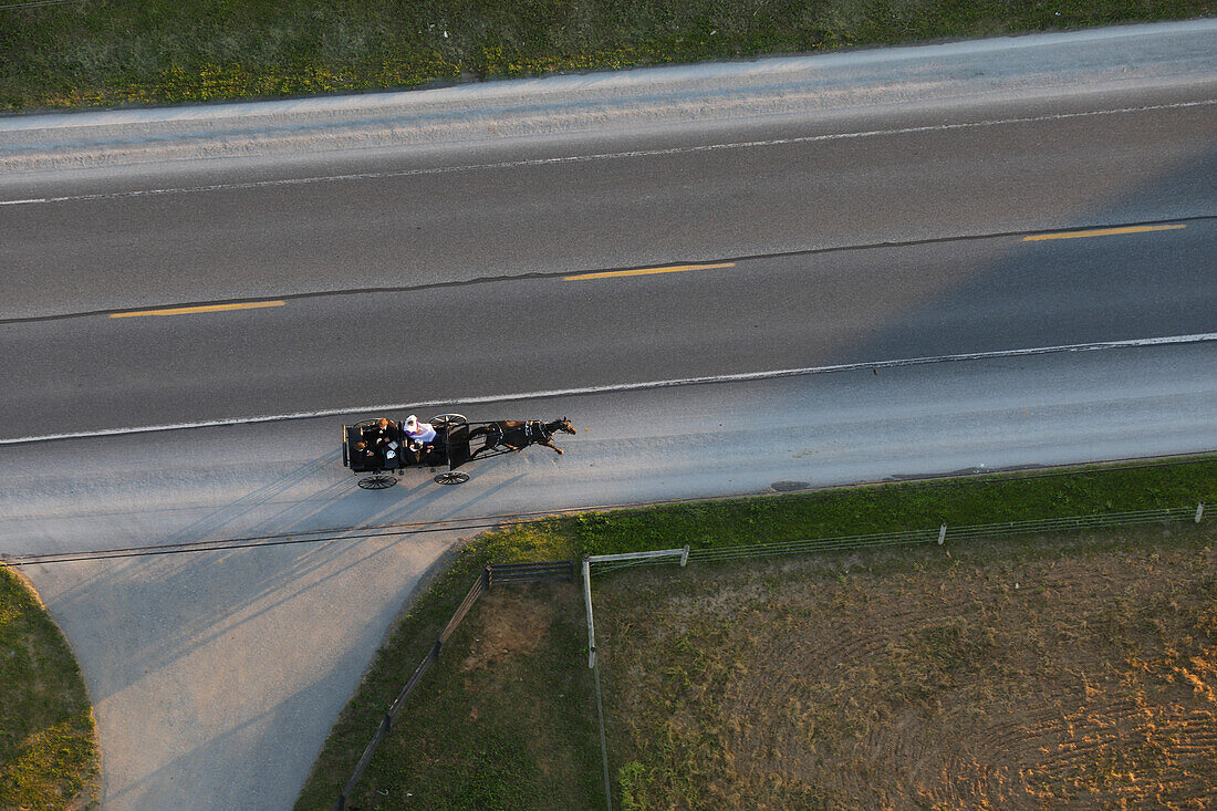 Aerial view of Amish carriage riding down road, Lancaster County, Pennsylvania, USA
