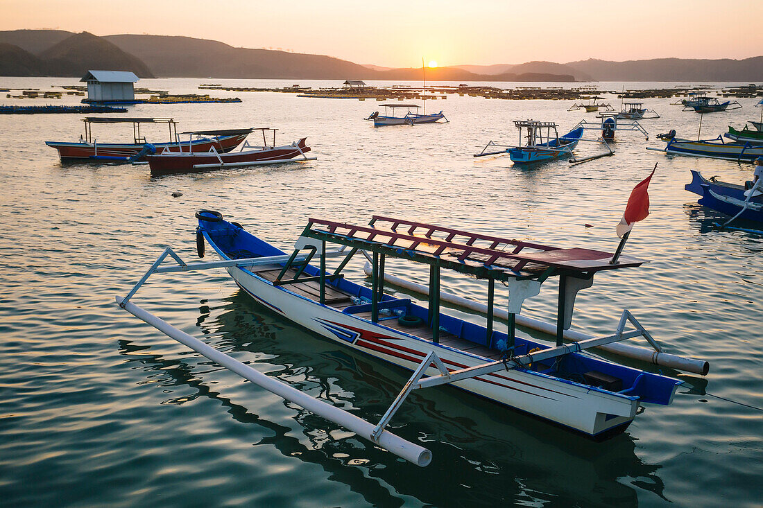 Lots of outrigger boats in sea at sunset, Kuta, Lombok, Indonesia