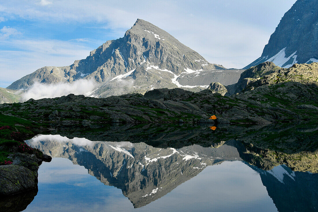 Mountain and tent mirrored on the lake, Lago Superiore, Superiore Lake, Piemonte,Piedmont,Italy