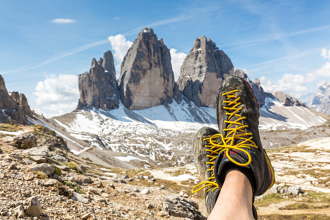 Mountaineer rests facing the Tre Cime Di Lavaredo, Dolomites, South Tyrol, province of Bolzano, Italy
