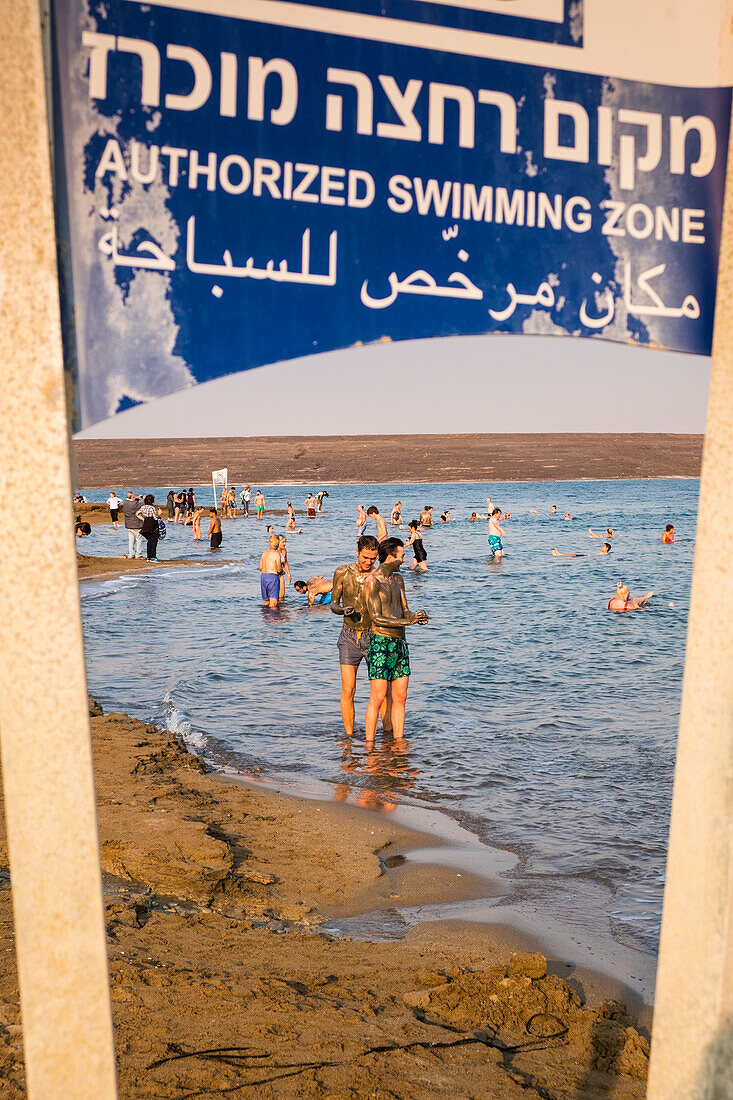 People enjoying the natural mineral mud sourced from the dead sea, North Dead Sea, West Bank, Palestine