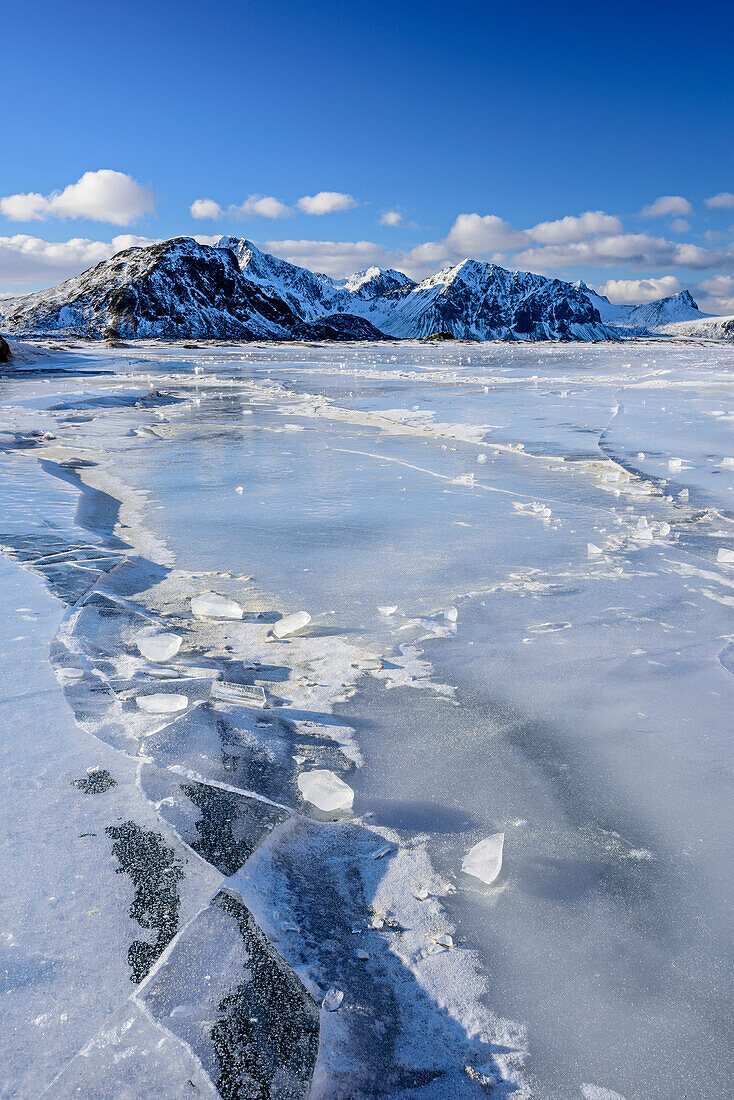 Icy beach with snow-covered mountains, Lofoten, Nordland, Norway