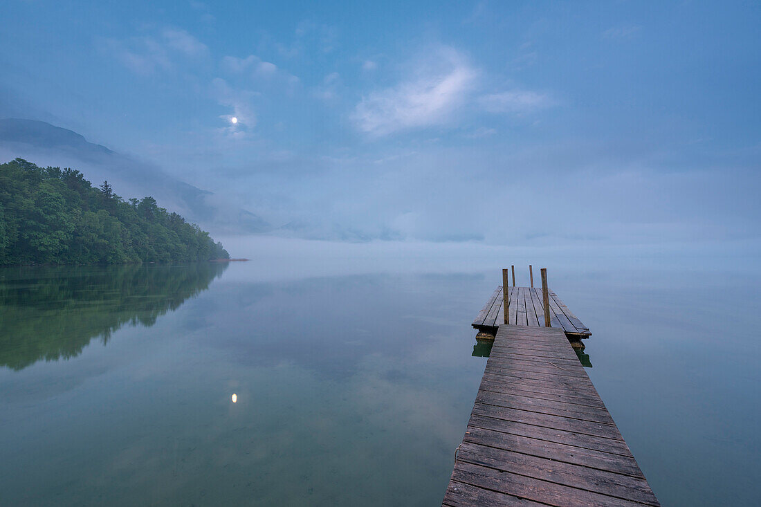 Kochel am See, Bad Tölz-Wolfratshausen district, Upper Bavaria, Germany, Europe. Jetty in the Kochel Lake at dawn