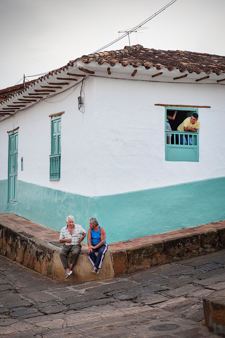 tow old men sitting at the pavement and having a conversation, Barichara, Departmento Santander, Colombia, Southamerica