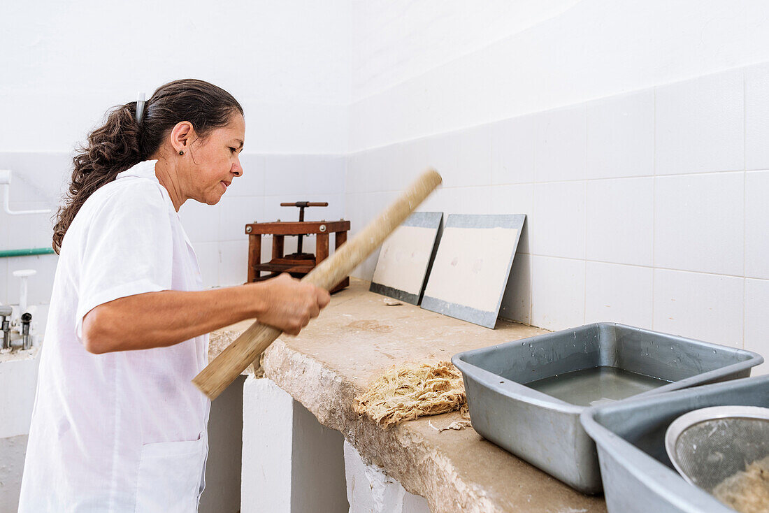 woman working at historical Paper Production at Fundación San Lorenzo, Barichara, Departmento Santander, Colombia, Southamerica